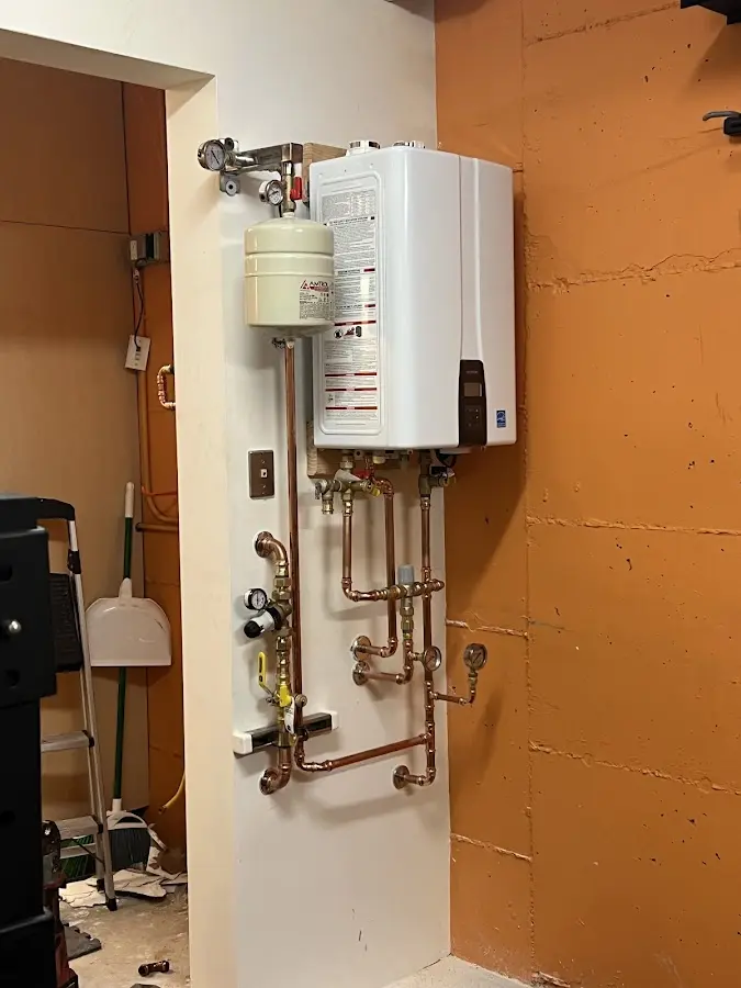 Plumbing technician inspecting water heater connections in Pompano Beach